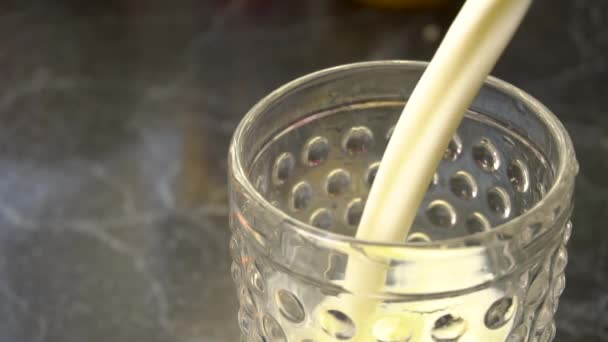 Dairy milk pouring into the glass — Stockvideo
