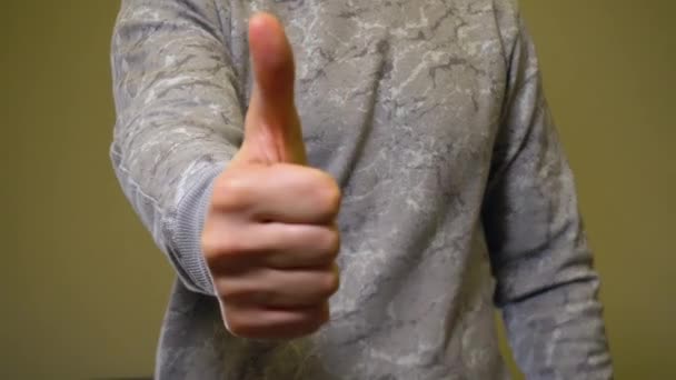 Closeup gesture thumbs up by man to camera — Stock Video