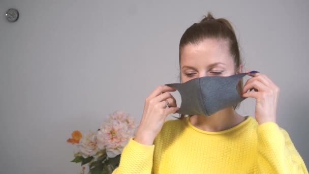 Woman wearing protective mask on her face at home — Stock Video