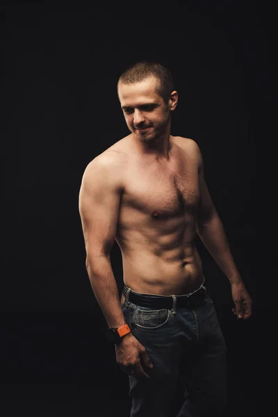 Shirtless man with natural real fit body standing in studio