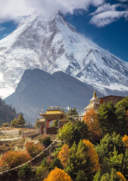 Traditional Buddhist monastery and Manaslu mount in Himalayas, Nepal.