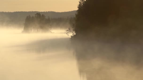 Lago nublado de la mañana. Humo moviéndose a lo largo de la superficie del agua en las luces del sol. UHD, 4K — Vídeos de Stock