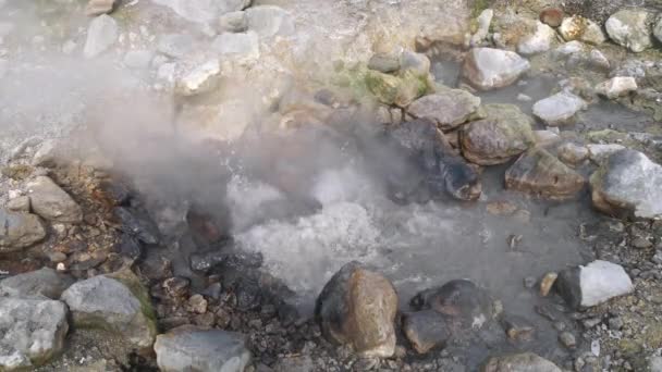 Water boiling in a hot spring among stones on Azores, Portugal. UHD — Stock Video