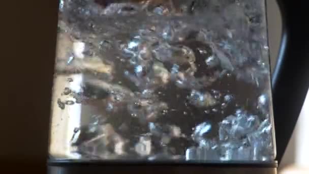 Water boiling in a glass teapod. Slow motion shot — Stock Video