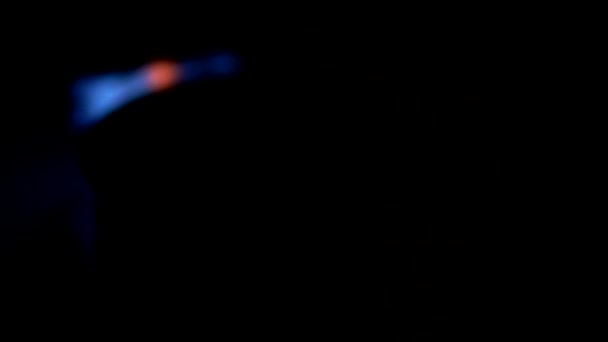 Firing up of gas stove in dark room. Methane burning with blue light. Slow motion shot — Stock Video