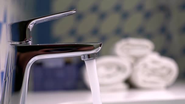 Water flowing from a shiny chrome plated water tap. Slow motion shot — Stock Video