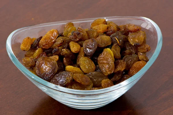 Dry and golden raisins in the bowl — Stock Photo, Image