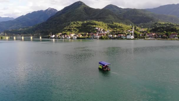 Mała łódź z turystami jadącymi po jeziorze Jablanica — Wideo stockowe