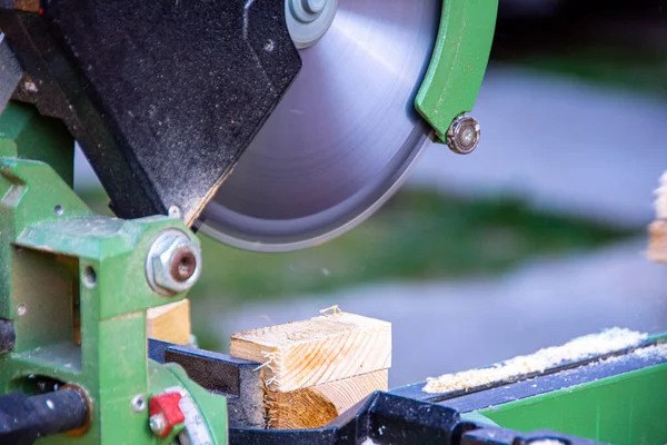 Man cutting wood using circular saw to create different products out of wood