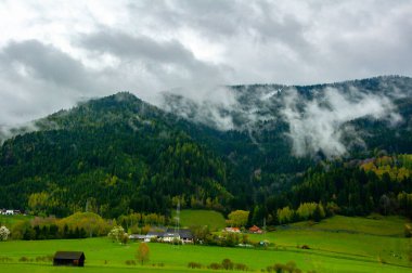 Avusturya 'daki dağın altındaki küçük köyün güzel manzarası