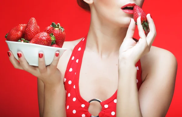 Woman with strawberry on the red background — Stock Photo, Image