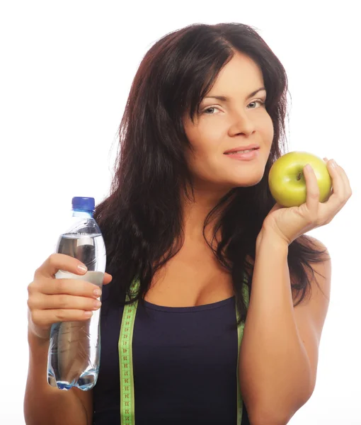 Modelo de fitness femenino sosteniendo una botella de agua y manzana verde — Foto de Stock