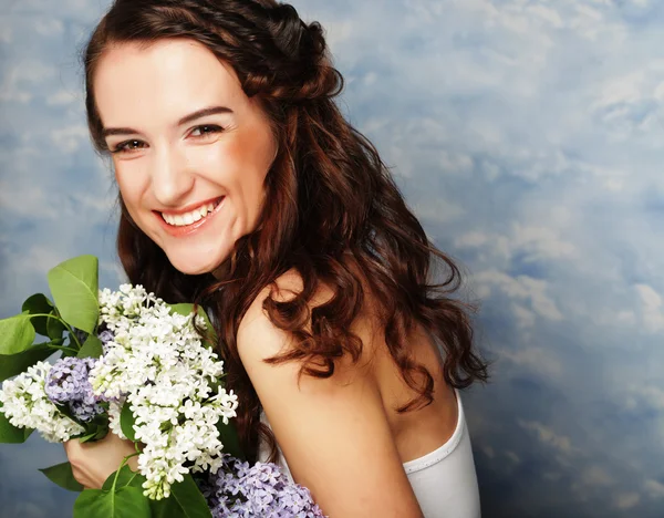 Young beautiful woman with lilac flowers — Stock Photo, Image