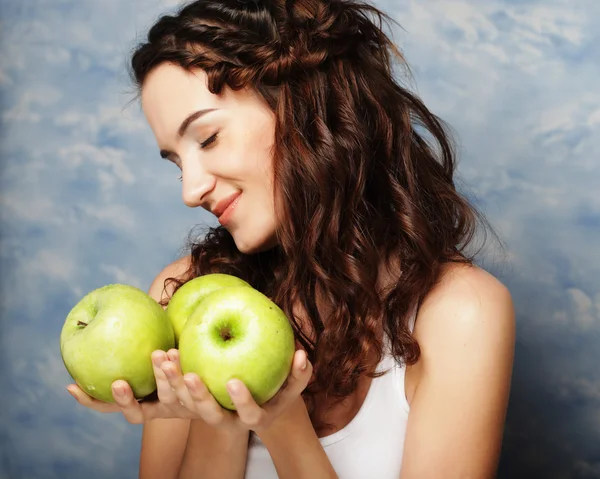 Young happy woman holding green apples. — Stock Photo, Image