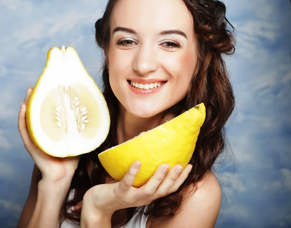 Mädchen hält große Zitrusfrüchte - Pamelo, über dem Himmel Hintergrund — Stockfoto