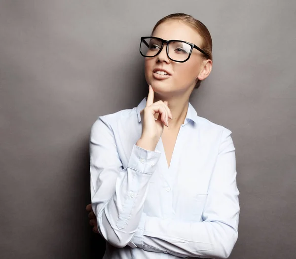Happy smiling young business woman in glasses, over grey  backgr — Stock Photo, Image