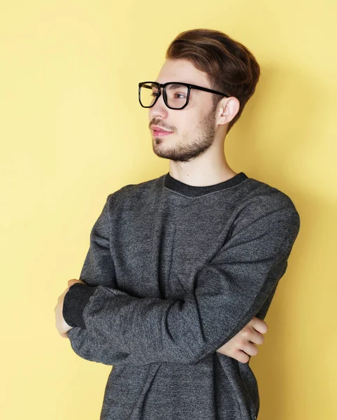 Man with great smile wearing fashion eyeglasses against  yellow — Stock Photo, Image