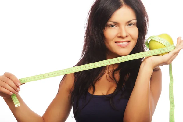 Hermosa mujer deportiva con manzana verde y cinta métrica —  Fotos de Stock