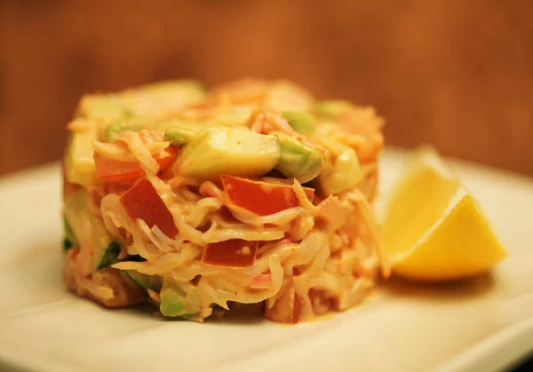 Salad and lemon on white plate — Stock Photo, Image