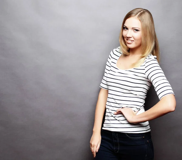 Beautiful smiling young woman.Over grey background. Stock Picture