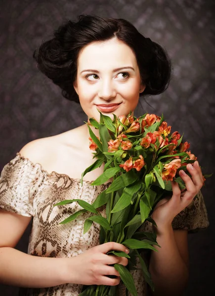 Young attractive young girl holds the bouquet of red and yellow — Stock Photo, Image