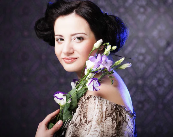 Beautiful brunette woman with lilac flowers — Stock Photo, Image