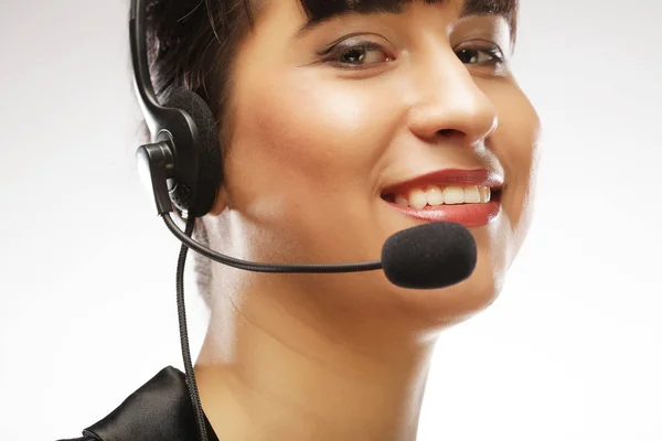 Portrait of smiling customer support female phone worker, over w — Stock Photo, Image