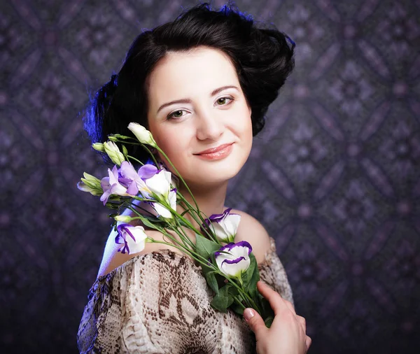 Beautiful brunette woman with lilac flowers — Stock Photo, Image