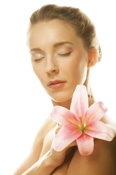 Skönhet ansikte av den unga kvinnan med rosa lilja — Stockfoto