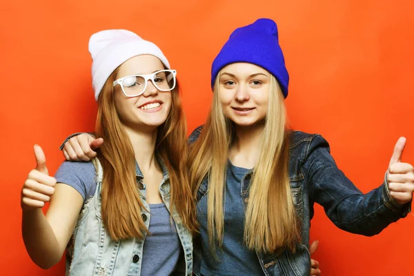 Dos amigas jóvenes de pie juntas y divirtiéndose. — Foto de Stock