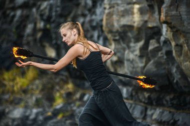 Alevli meşalelerle siyah elbiseli kız .