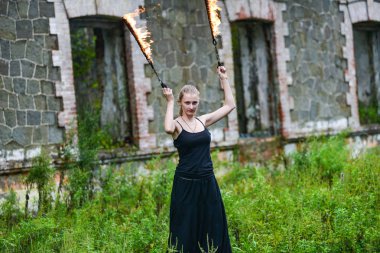 Alevli meşalelerle siyah elbiseli kız .