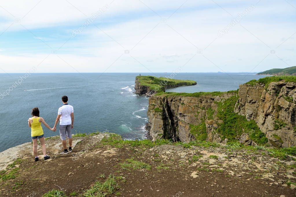 Two people standing on top of a mountain