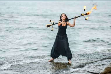 Deniz kıyısında ateş gösterisi ile oynamak