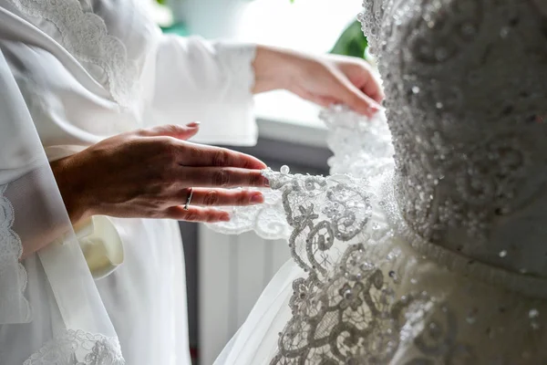 抱着新娘婚纱礼服伴娘 — 图库照片