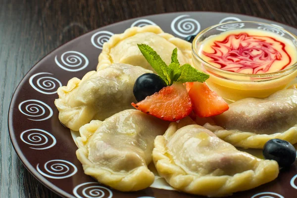 Delicious dumplings with cherries and jam — Stock Photo, Image