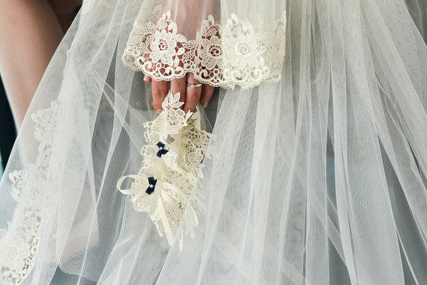 Garter on the leg of a bride, Wedding day moments