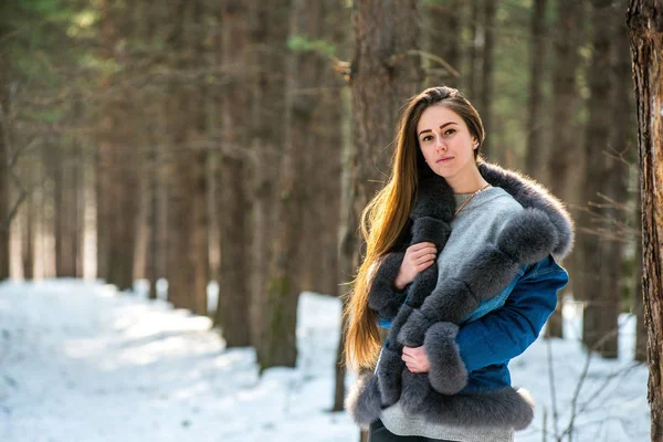 Young hipster woman in winter forest having fun with snow — Stock Photo, Image