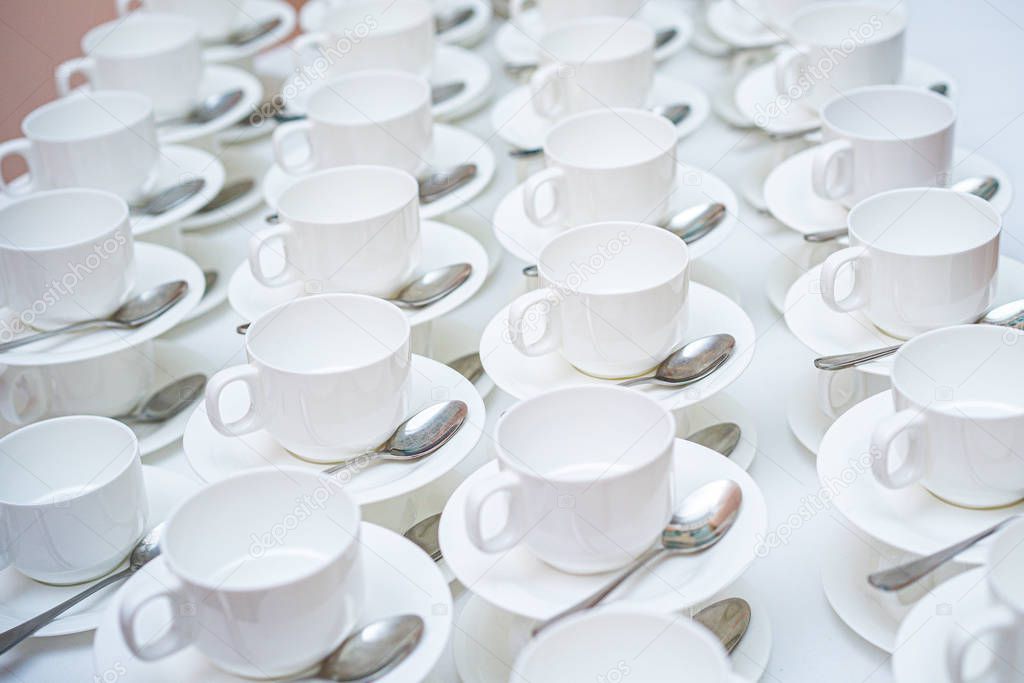 A lot of white coffee cups. Top view on many stacked in rows of empty clean white cups for tea or coffee