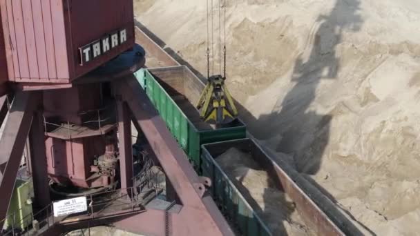 Loading sand into rail cars with the help of a career excavator — Stock Video