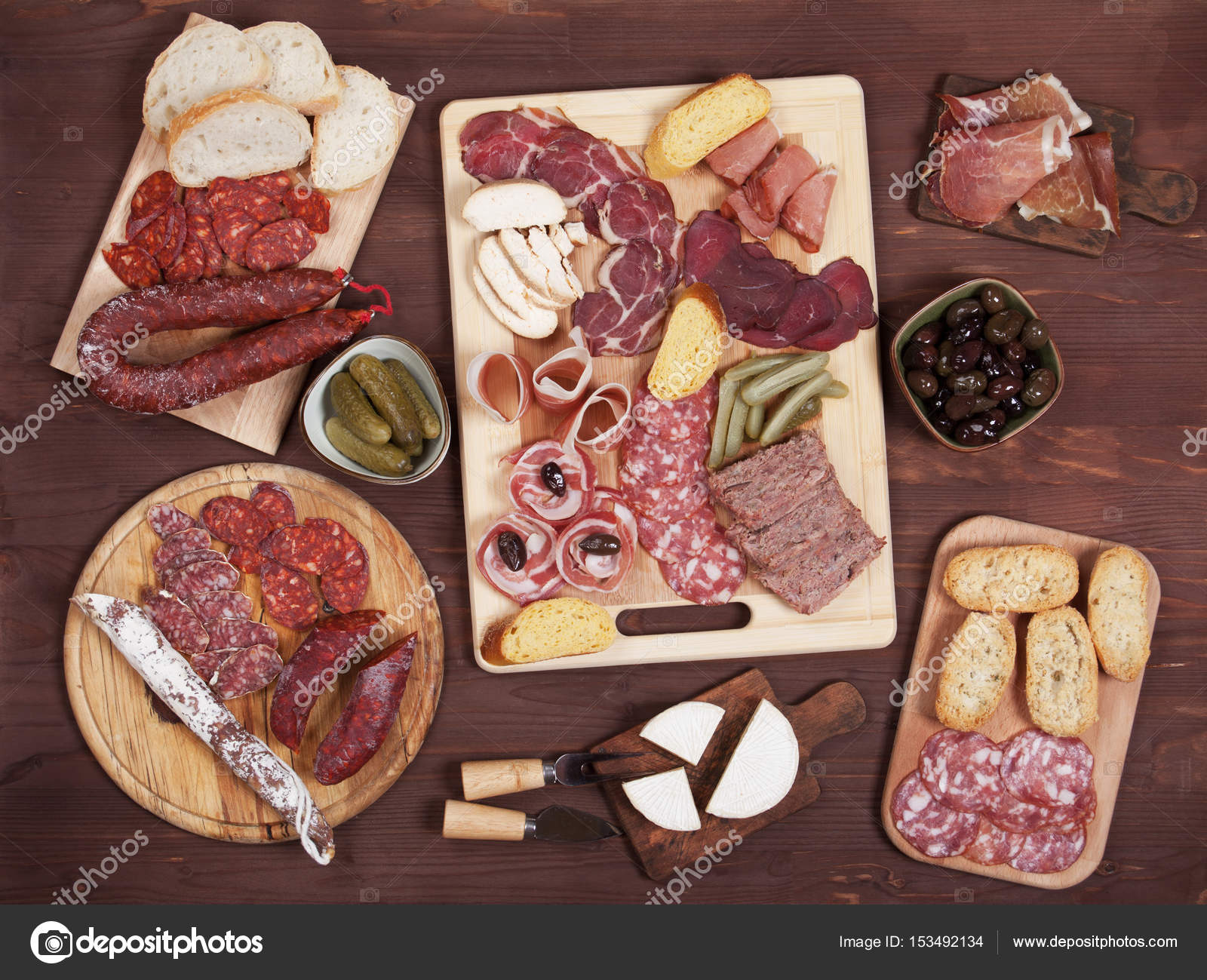 Charcuterie board with cured meat and olives Stock Photo by ©igordutina