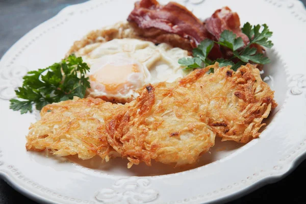 Hash browns with egg and bacon — Stock Photo, Image