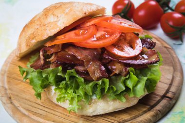 BLT sandwich with fried bacon, lettuce and tomato in slices of bread clipart