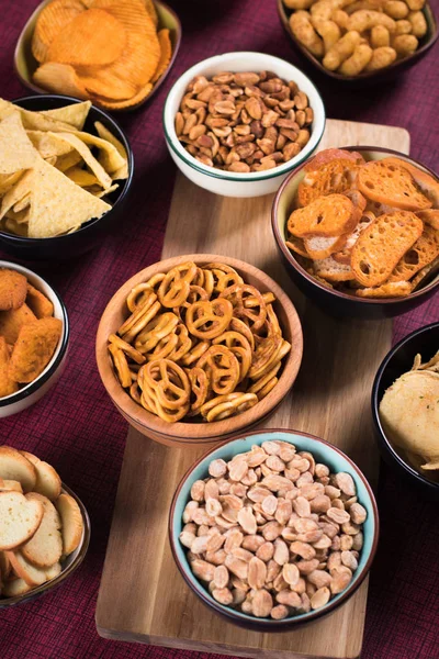 Salty snacks served in bowls — Stock Photo, Image