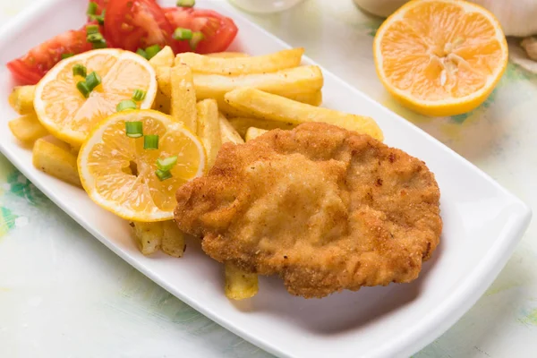 Breaded cutlet with french fries — Stock Photo, Image