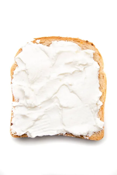 Slice of bread with sour cream spread on top — Stock Photo, Image