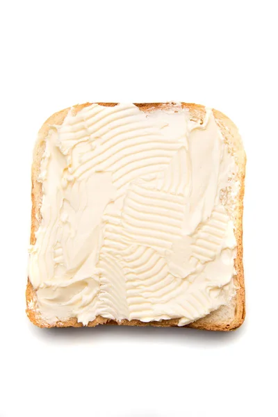 Fatia de pão com manteiga espalhada por cima — Fotografia de Stock