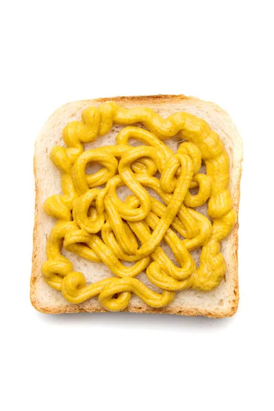 Tranche de pain avec tartinade de moutarde jaune sur le dessus — Photo