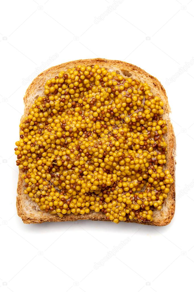 Slice of bread with wholegrain mustard spread on top