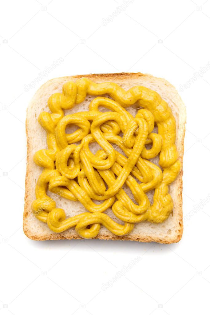 Slice of bread with yellow mustard spread on top
